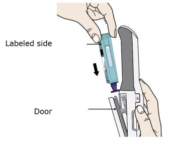 Hold the Enbrel Mini single-dose cartridge with the labeled side facing out and slide into door image.