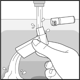 Turn the actuator upside down and run warm water through the mouthpiece for about 30 seconds.