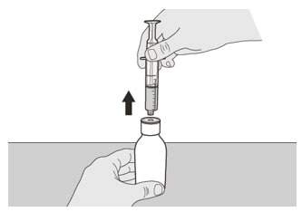 Continue to hold the plunger in place to keep the plunger from moving. Leave the oral syringe in the bottle adapter and turn the bottle to an upright position. Place the bottle onto a flat surface. Remove the oral syringe from the bottle adapter by gently pulling straight up on the oral syringe while holding the plunger in place.image