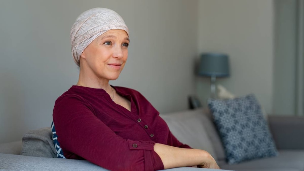 Woman wearing head scarf who has hair loss due to chemotherapy.