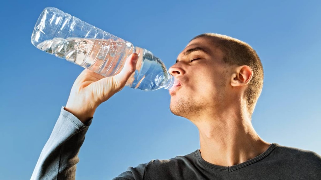 Man drinking water from a bottle.