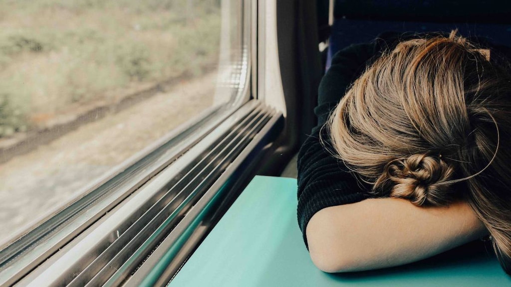 woman head in arms on table sleeping. photo credit Abbie Bernet.image