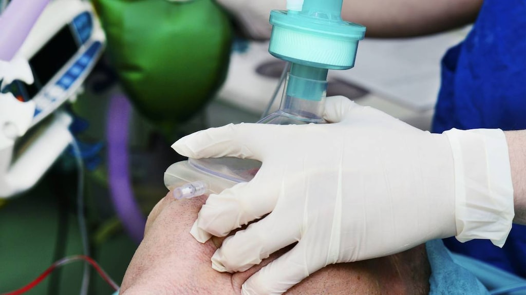 Surgeon using anesthesia on patient