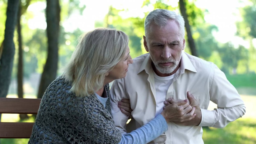 Woman with a man with hand on chest