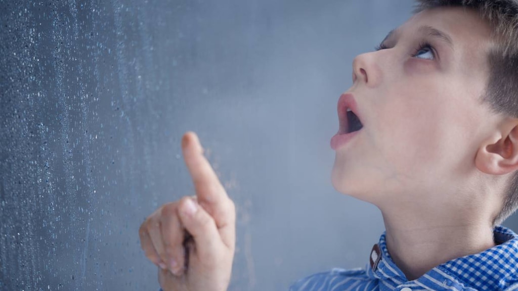 Boy with Aspergers looking at rain