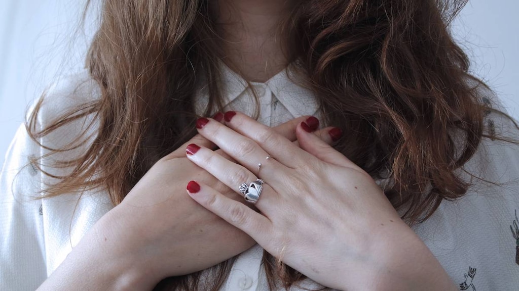 Woman with hands on chest