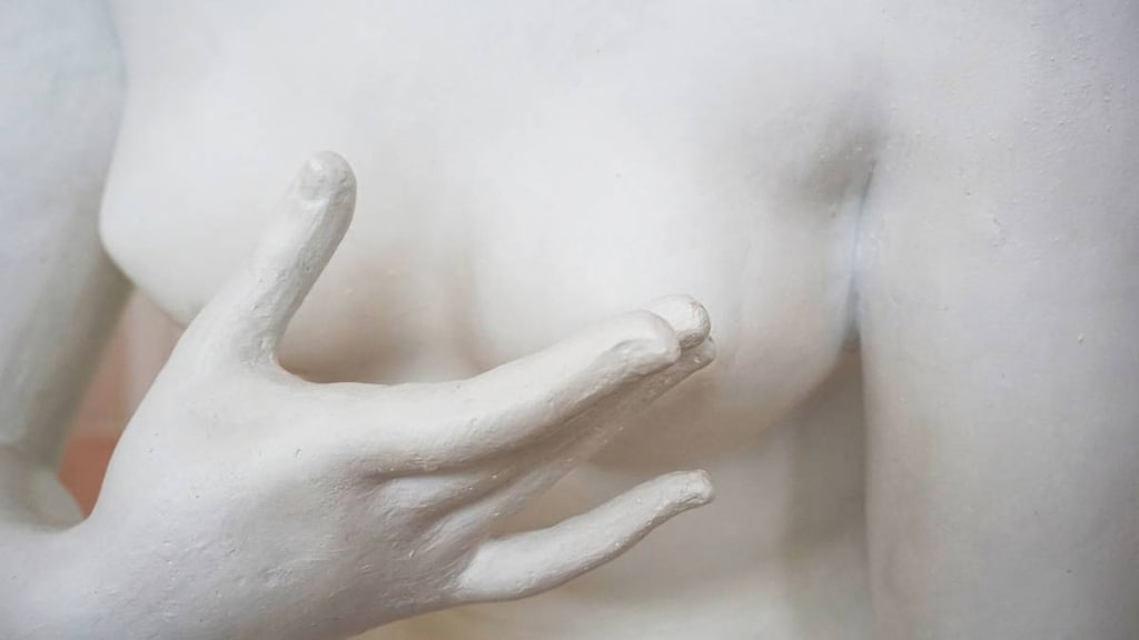 Sculpture showing breast being checked