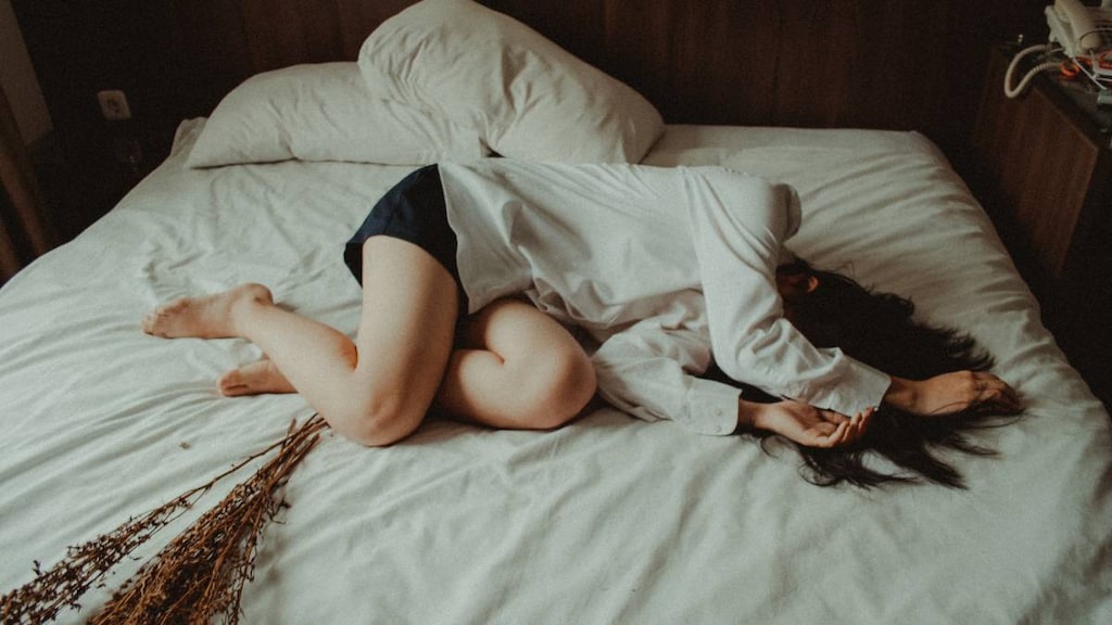 Exhausted woman on bed