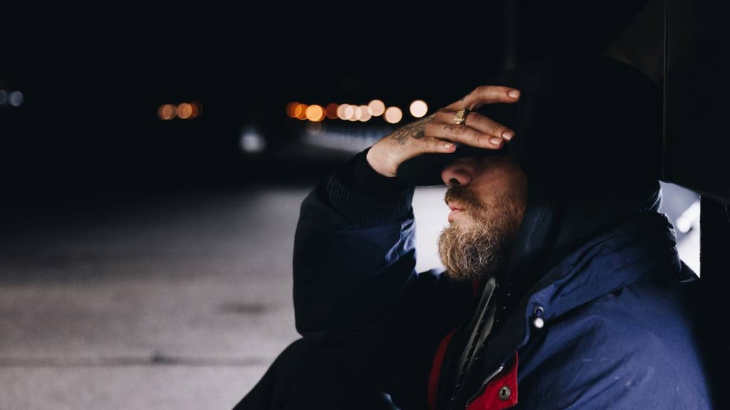 Man with depression sitting in the dark