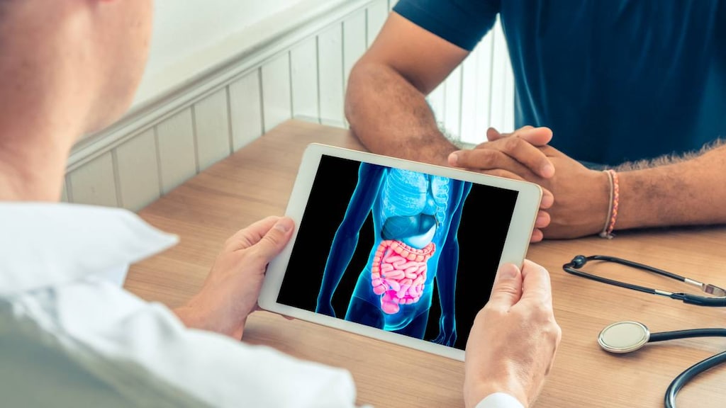 Doctor holding tablet with intestine image