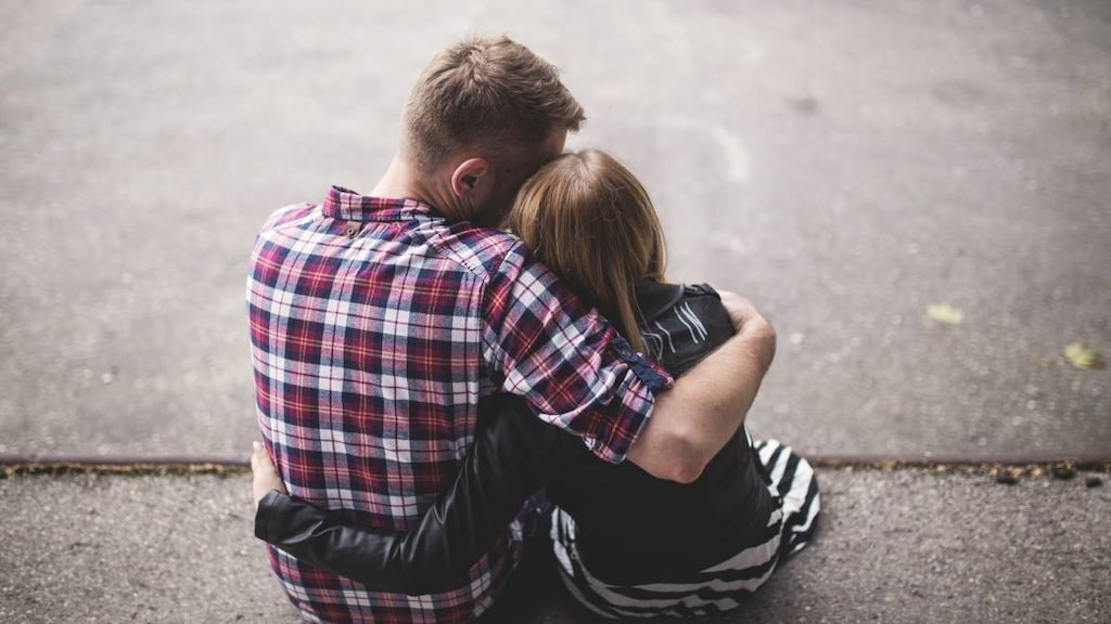 Man comforting unwell woman.