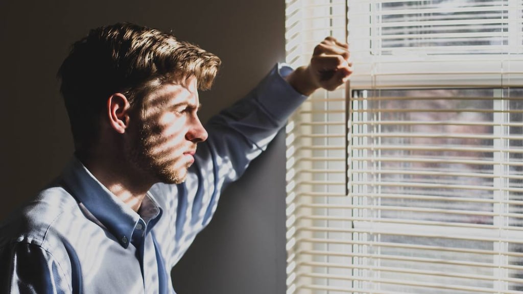 Man looking out of window