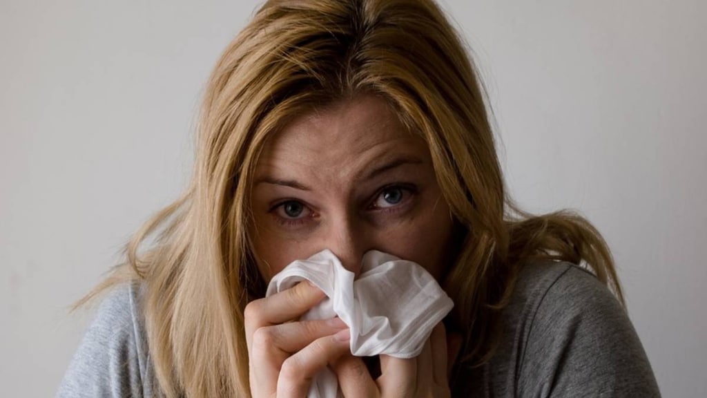 Woman blowing nose