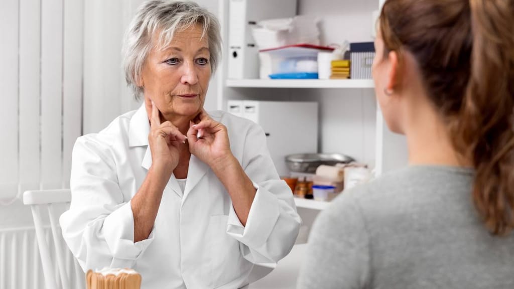 Doctor demonstrating checking neck glands to patient