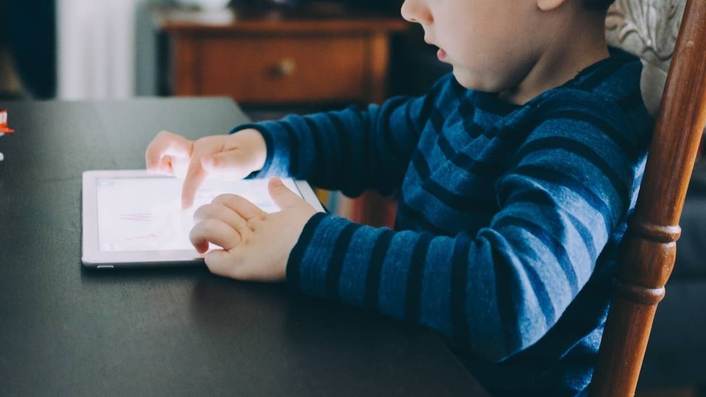 Child playing a video game on a tablet