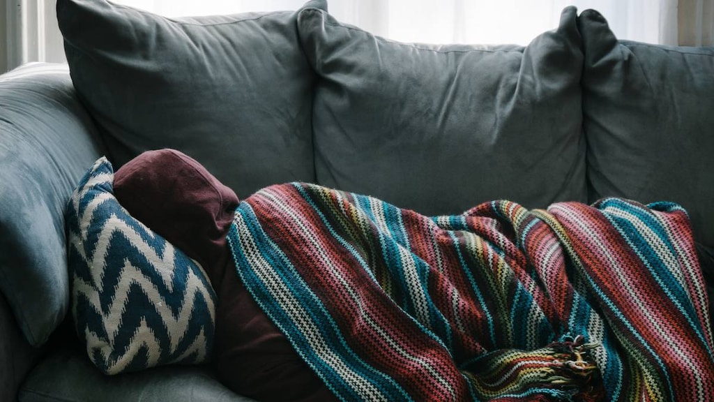 Sick person lying on couch