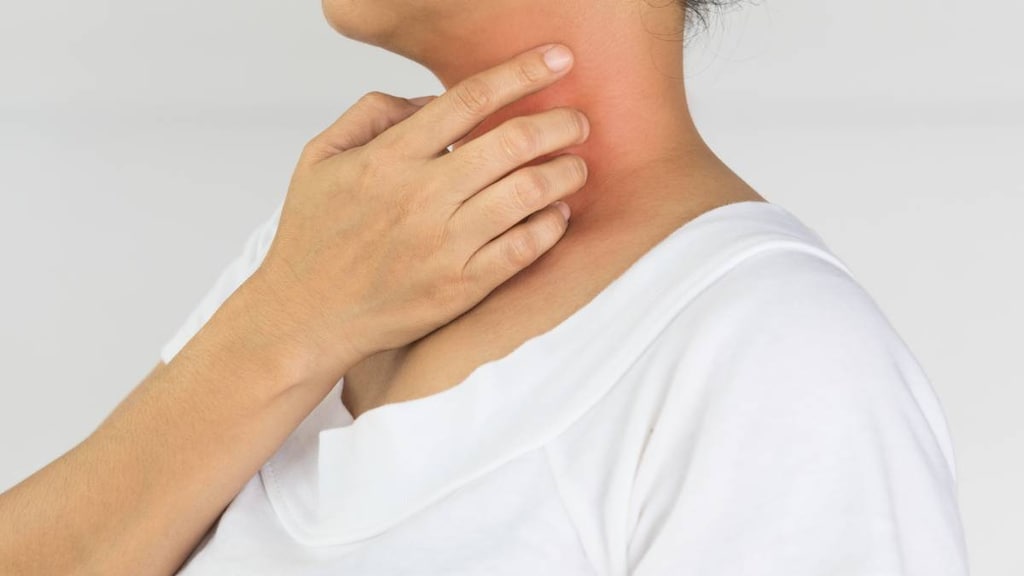 Woman scratching her neck