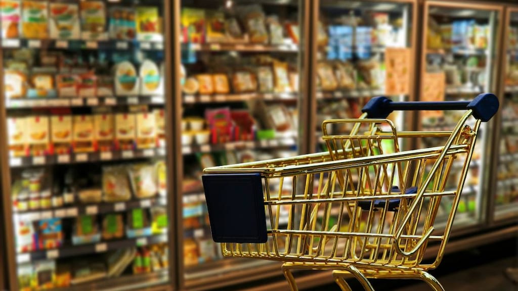 Empty shopping cart in grocery store.