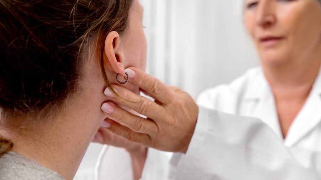 Doctor feeling woman's glands