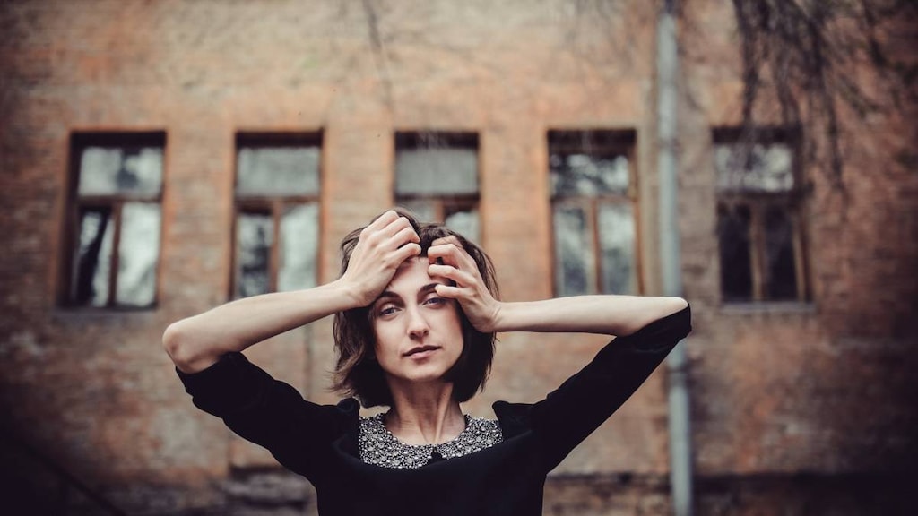 Woman with hands on head