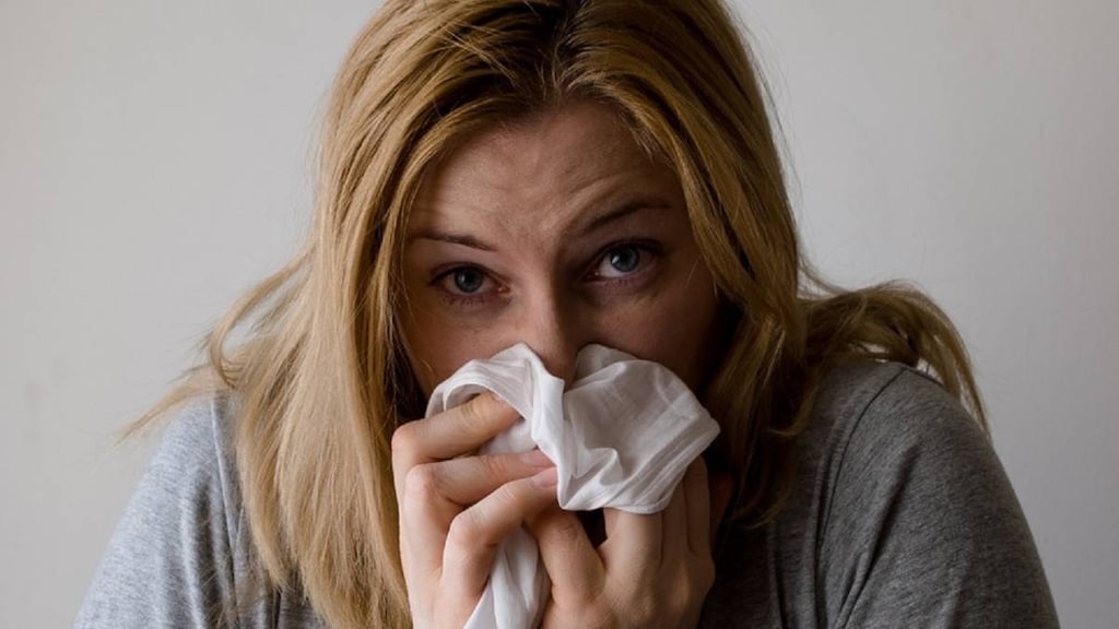 Woman blowing her nose