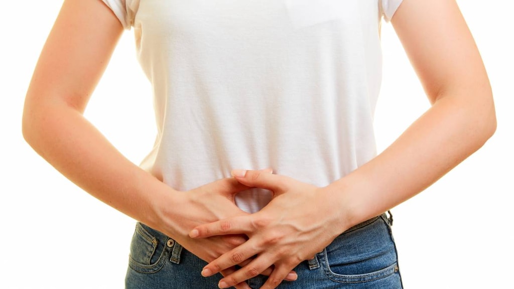 Woman with hands over abdomen