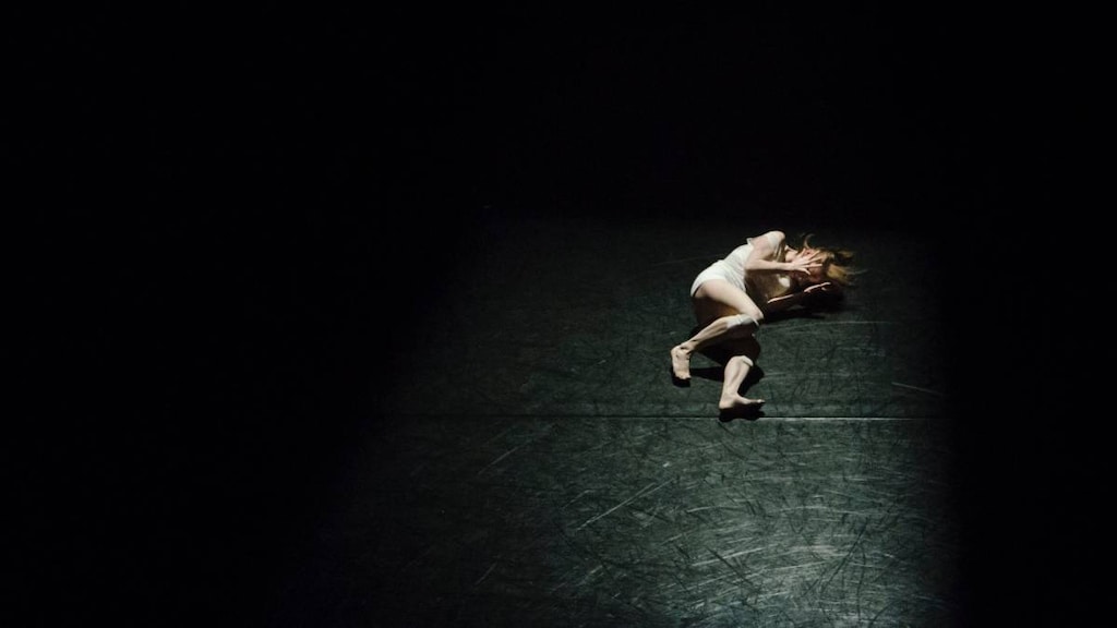 Woman in pain on a dark background