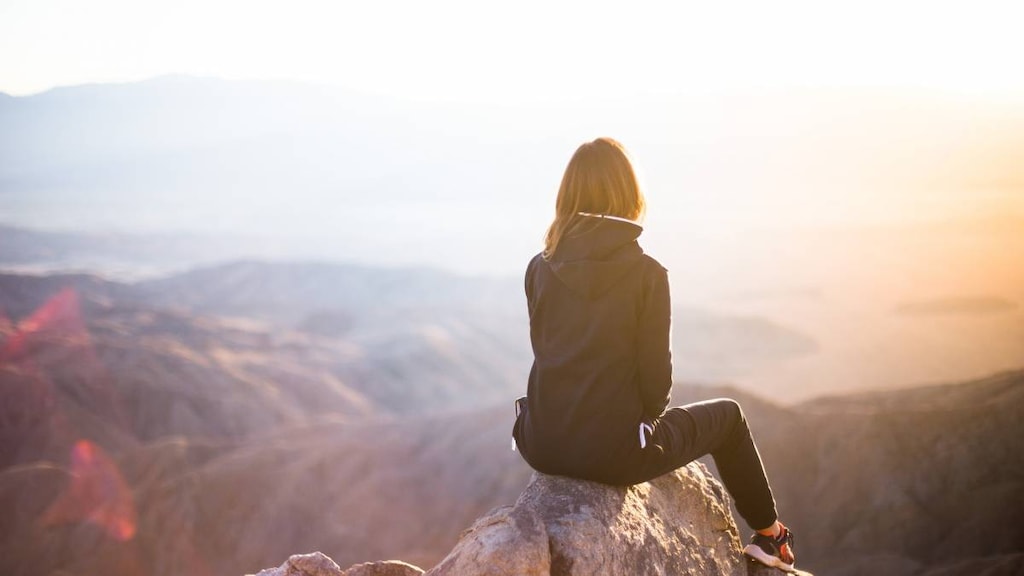 Woman sitting on a rock