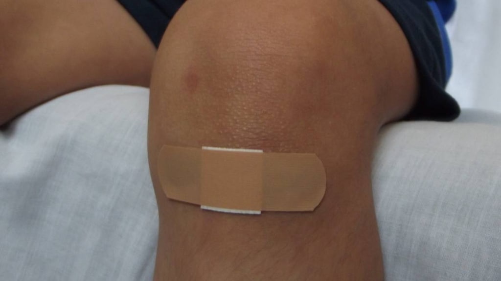 Knee with a plaster on it.